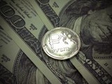 К закрытию торгов курс российской валюты вырос на 5 рублей к доллару